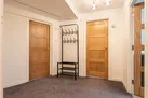 Large hallway with coat hooks and shoe rack