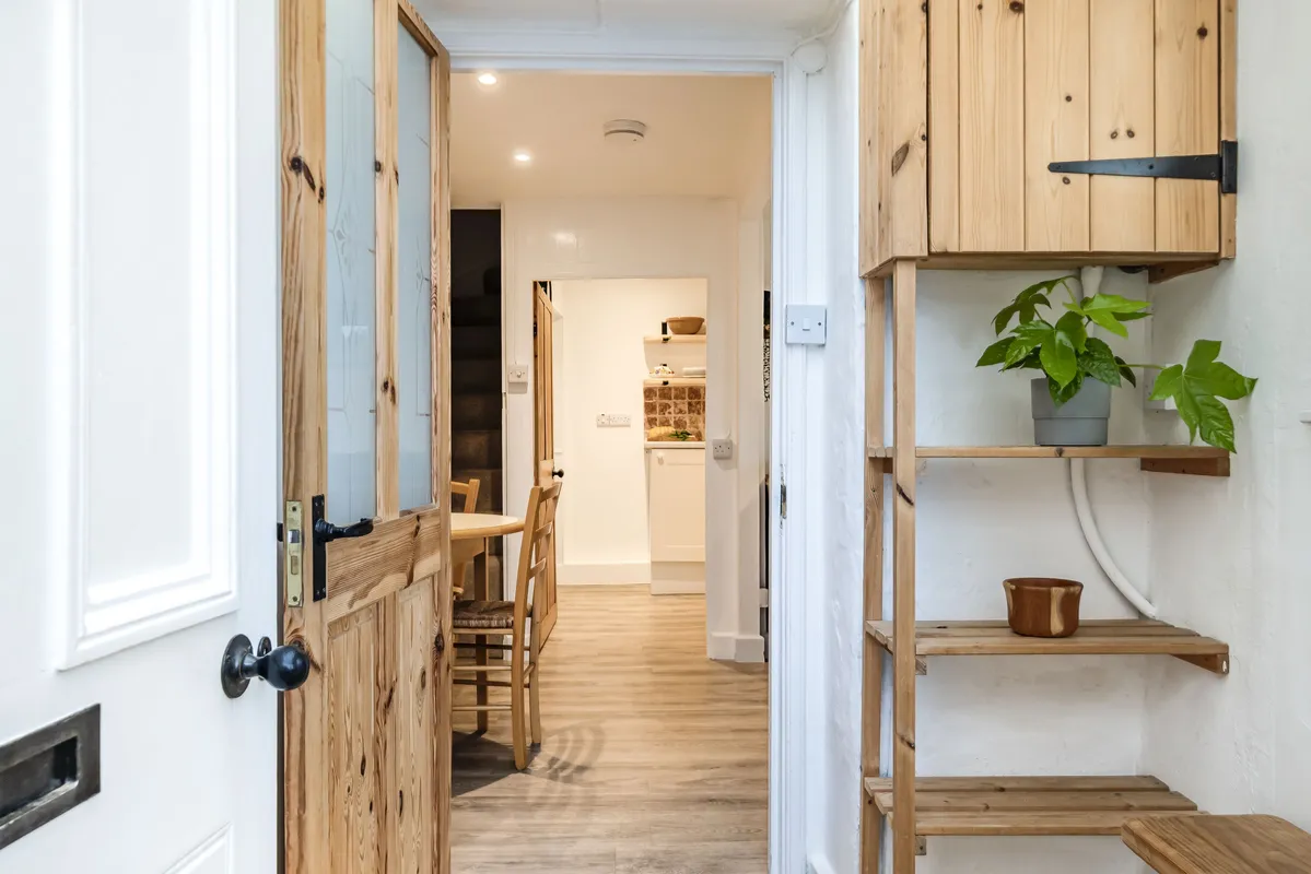 Meads Cottage, Charmouth: A stylish and functional porch shoe rack designed to keep your entryway organised