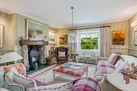 The seating area in the drawing room with log burner.