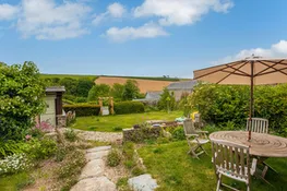 Looking from the front of the house across the lawn and over to the fields beyond.