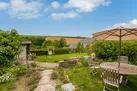 Looking from the front of the house across the lawn and over to the fields beyond.