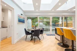 The breakfast bar and breakfast table, overlooking the rear terrace
