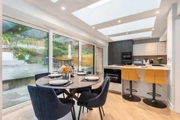 The well equipped kitchen with breakfast bar and smaller dining table, overlooking the rear terrace.