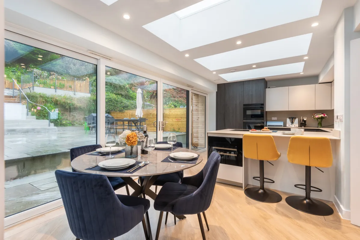 The well equipped kitchen with breakfast bar and smaller dining table, overlooking the rear terrace.
