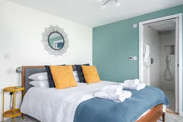 Bedroom 1, sea views, king size bed and a modern en suite shower room.