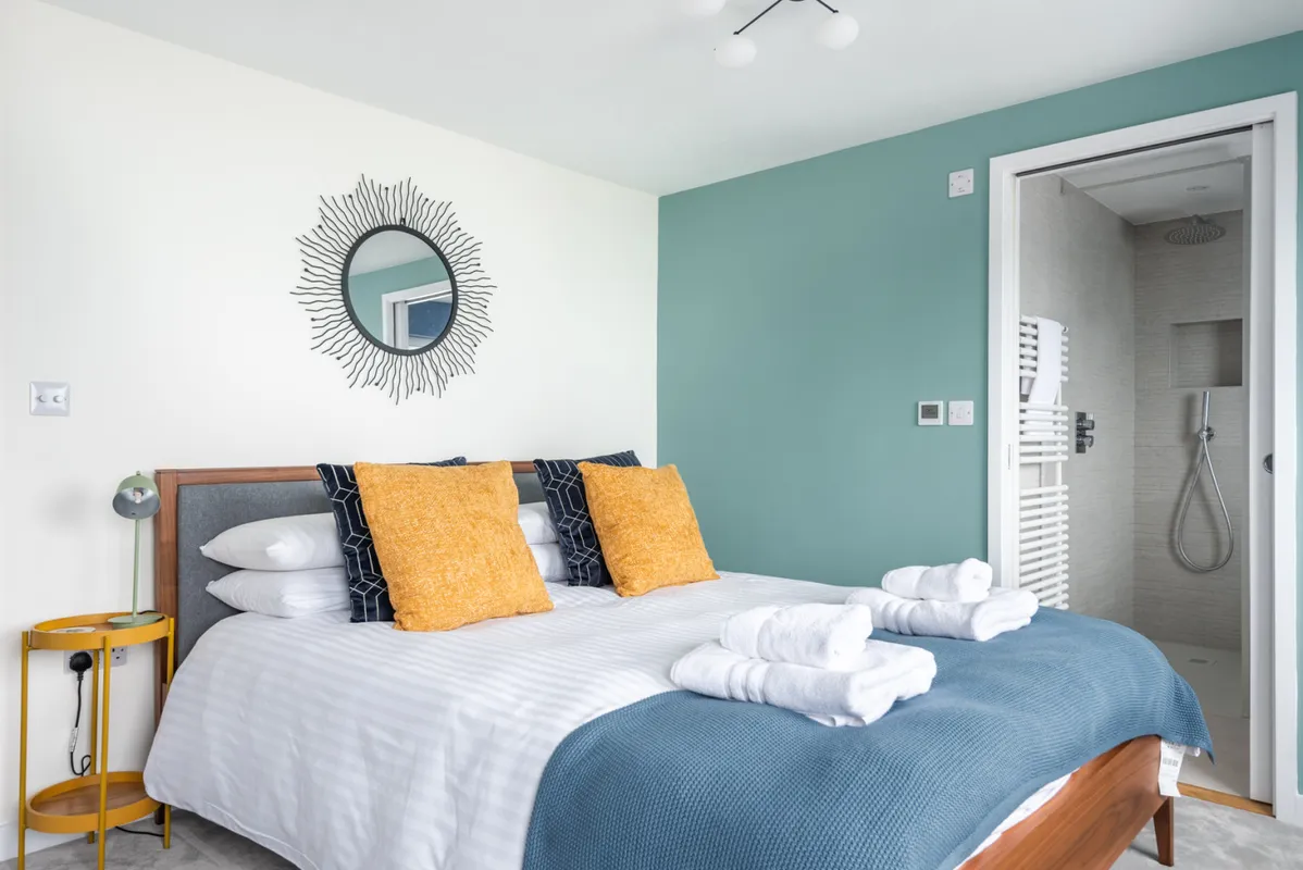 Bedroom 1, sea views, king size bed and a modern en suite shower room.