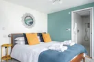 Bedroom 1, sea views, king size bed and a modern en suite shower room.