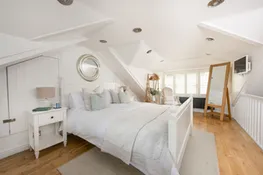 Master bedroom with king sized bed and full length mirror - Happy Days Cottage