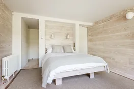 The master bedroom in the modern extension looks over the rear garden