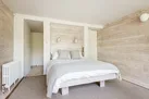 The master bedroom in the modern extension looks over the rear garden