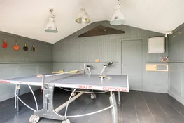 The games room with table tennis, dart board and spin bike!