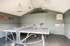 The games room with table tennis, dart board and spin bike!