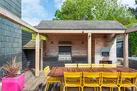 The outdoor living space with space to dine, recline, cook and relax