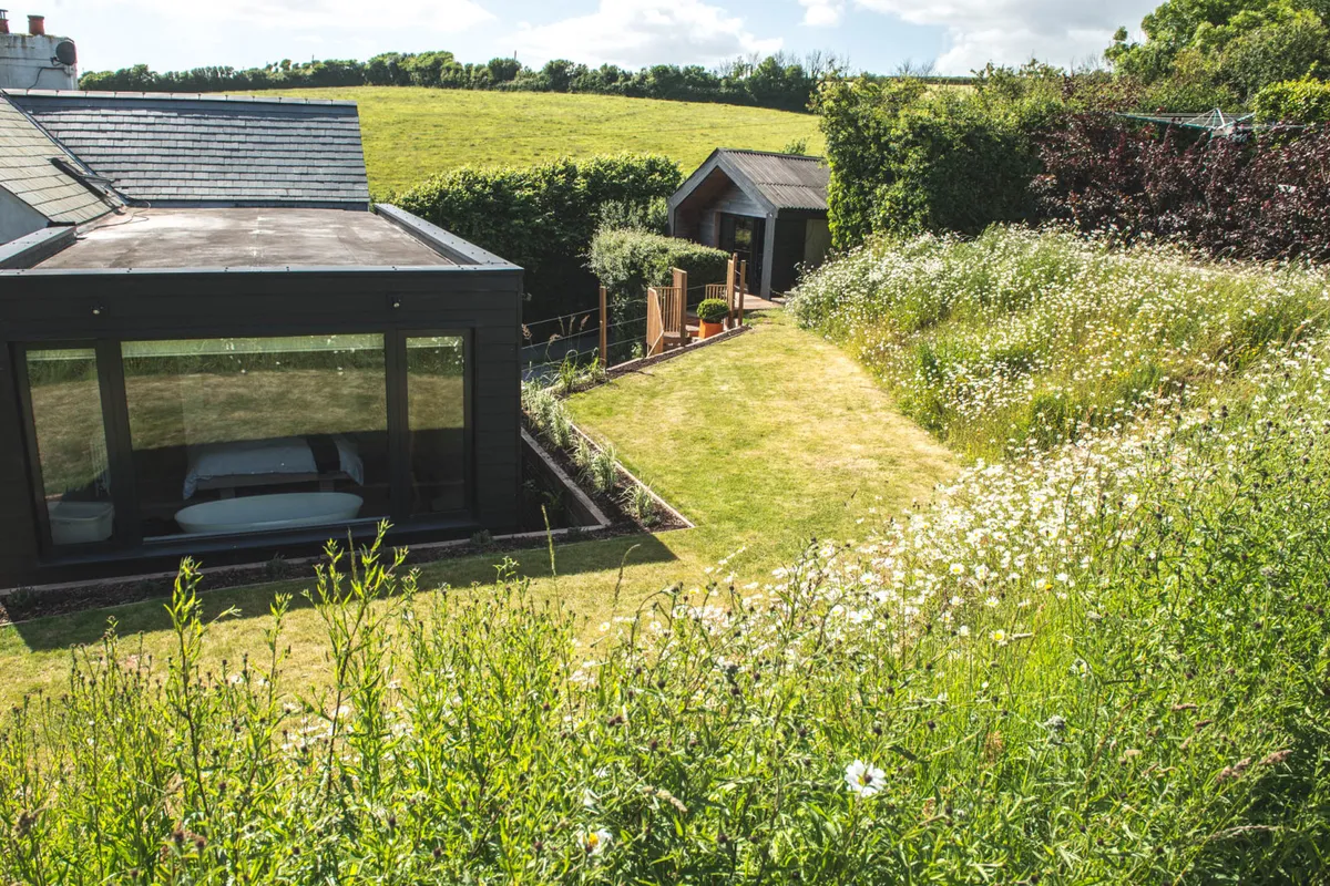 The modern master bedroom looks out over the garden