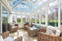 The sun room offers additional living space and views over the tranquil garden