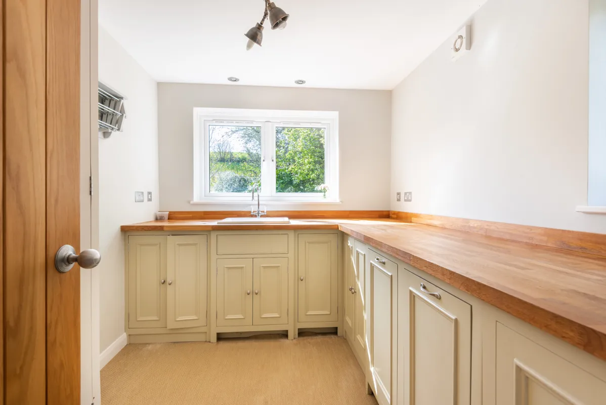 Very useful utility room with freezer, washing machine and tumble dryer, drying rack and sink