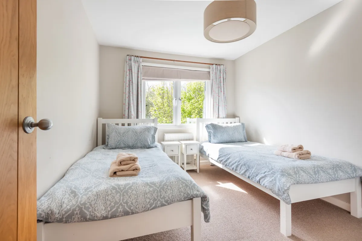 Bedroom 3 with views over the garden to the green field next door and twin 3' single beds