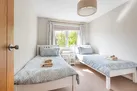 Bedroom 3 with views over the garden to the green field next door and twin 3' single beds