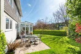 The pretty garden surrounds the house to the parking area