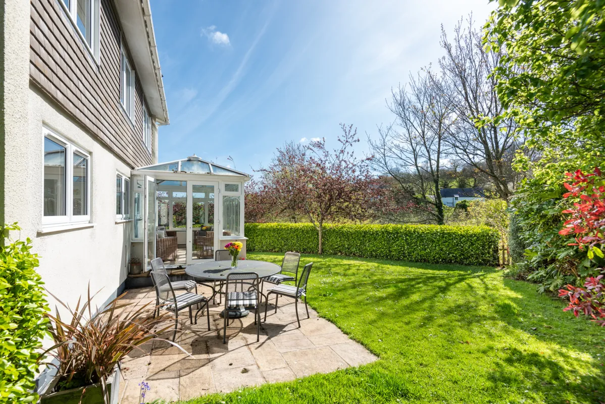 The pretty garden surrounds the house to the parking area